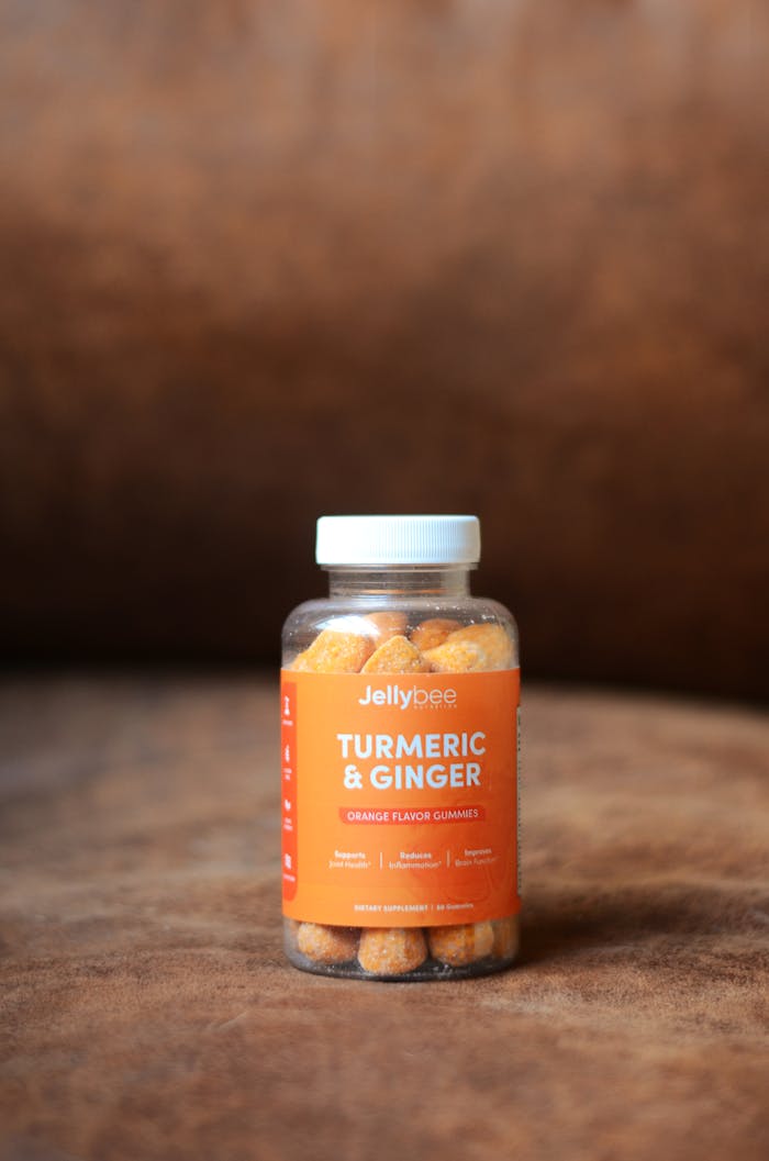 Bottle of Jellybee turmeric and ginger gummies promoting health and immunity with orange flavor.